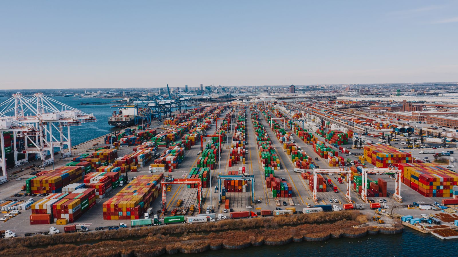 Aerial view of containers, cranes, yard roads and vessels at a terminal.
